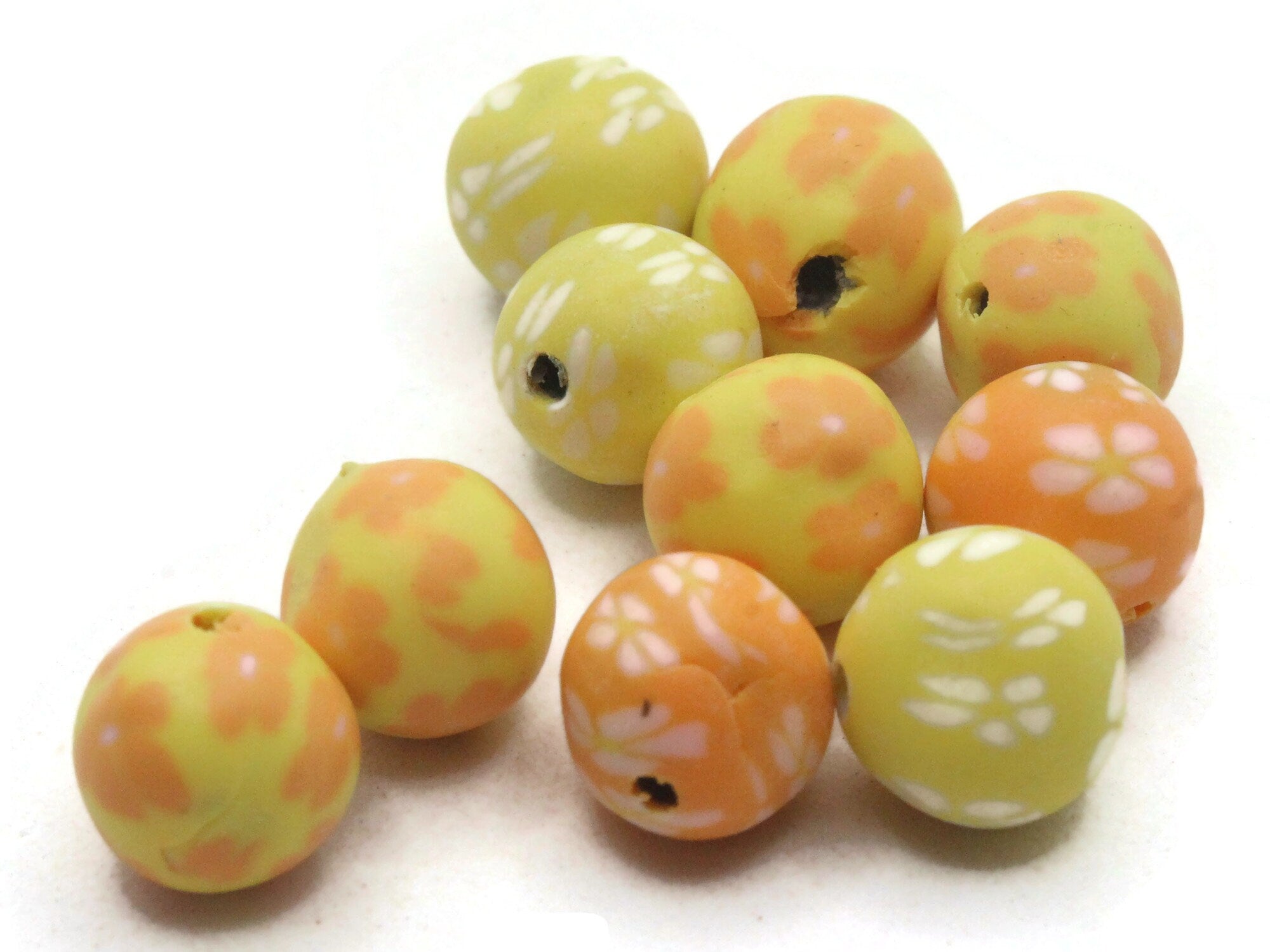 Bead, polymer clay, white / black / yellow, 14mm double-sided flat round  with awareness ribbon. Sold per pkg of 30. - Fire Mountain Gems and Beads